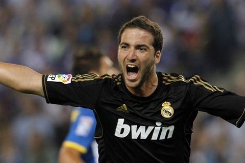 Real Madrid's Gonzalo Higuain celebrates a goal against Espanyol during their Spanish First division soccer match at Cornella-El Prat stadium, near Barcelona, October 2, 2011. REUTERS/Albert Gea (SPAIN - Tags: SPORT SOCCER)