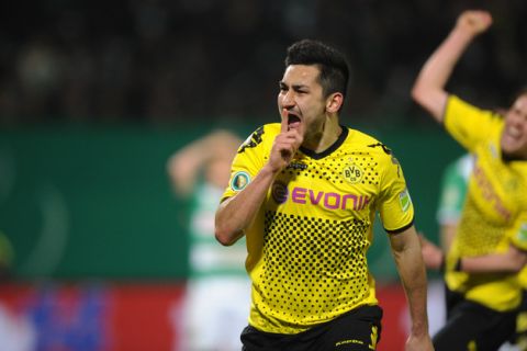 Dortmund's midfielder Ilkay Guendogan celebrates the 0-1 during the German Football League DFB Cup semi-final match between SpVgg Greuther Fuerth and Borussia Dortmund in Fuerth, southern Germany, on March 20, 2012. Dortmund won the match 0-1.       AFP PHOTO / CHRISTOF STACHE

RESTRICTIONS / EMBARGO - DFL LIMITS THE USE OF IMAGES ON THE INTERNET TO 15 PICTURES (NO VIDEO-LIKE SEQUENCES) DURING THE MATCH AND PROHIBITS MOBILE (MMS) USE DURING AND FOR FURTHER TWO HOURS AFTER THE MATCH. FOR MORE INFORMATION CONTACT DFL. (Photo credit should read CHRISTOF STACHE/AFP/Getty Images)