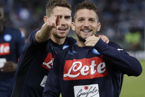 Napoli's Jorginho, left, celebrates with his teammate Dries Mertens after scoring during a Serie A soccer match between Lazio and Napoli, at the Rome Olympic stadium, Wednesday, Sept. 20, 2017. (AP Photo/Alessandra Tarantino)