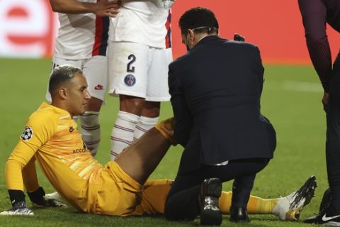 PSG's goalkeeper Keylor Navas, bottom, receives first aid after an injuring during the Champions League quarter-final soccer match between Atalanta and Paris Saint-Germain, at the Luz stadium in Lisbon, Portugal, Wednesday, Aug. 12, 2020. (Rafael Marchante/Pool via AP)