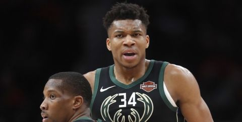 Milwaukee Bucks forward Giannis Antetokounmpo (34) is held back by Milwaukee Bucks guard Eric Bledsoe (6) as he argues with an official in the second half of an NBA basketball game against the Atlanta Hawks Sunday, Jan. 13, 2019, in Atlanta. Milwaukee won 133-114. (AP Photo/John Bazemore)
