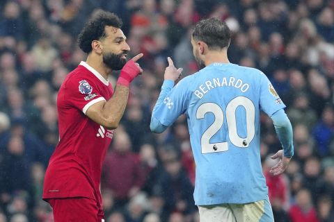 Liverpool's Mohamed Salah, left, and Manchester City's Bernardo Silva argue during the English Premier League soccer match between Liverpool and Manchester City, at Anfield stadium in Liverpool, England, Sunday, March 10, 2024. (AP Photo/Jon Super)