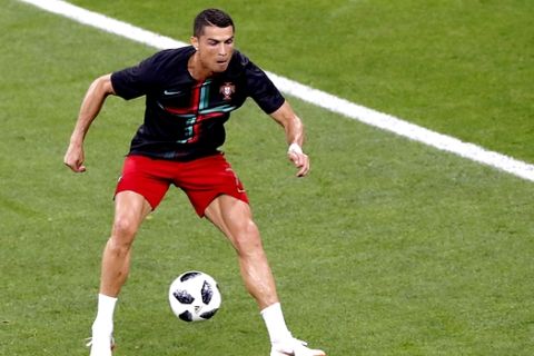 Portugal's Cristiano Ronaldo warms up prior to the start of the group B match between Iran and Portugal at the 2018 soccer World Cup at the Mordovia Arena in Saransk, Russia, Monday, June 25, 2018. (AP Photo/Darko Bandic)