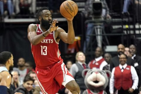 Houston Rockets' James Harden (13) passes the ball as Memphis Grizzlies' Joakim Noah (55) and Garrett Temple, left, defend during the second half of an NBA basketball game Monday, Jan. 14, 2019, in Houston. The Rockets won 112-94. (AP Photo/David J. Phillip)