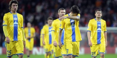 Bate Borisov's midfielder Dmitri Baga (L) and midfielder Aleksandr Karnitski (C) react after being defeated at the end of the UEFA Champions League Group H football match Athletic Club Bilbao vs FC BATE Borisov, at the San Mames stadium in Bilbao on December 10, 2014. Athletic won 2-0.    AFP PHOTO/ ANDER GILLENEA        (Photo credit should read ANDER GILLENEA/AFP/Getty Images)