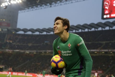 Fiorentina's Federico Chiesa smiles as he holds the ball during a Serie A soccer match between AC Milan and Fiorentina, at the San Siro stadium in Milan, Italy, Saturday, Dec. 22, 2018. (AP Photo/Luca Bruno)