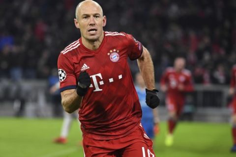 Bayern Munich's Arjen Robben celebrates after scoring the opening goal during the soccer Champions league group E match between Bayern Munich and Benfica Lisbon in Munich, southern Germany, Tuesday, Nov. 27,  2018. (Sven Hoppe/dpa via AP)