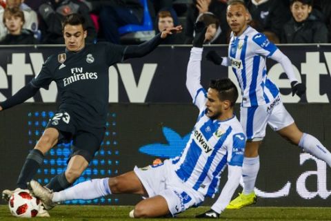 Real Madrid's Reguilon, left, duels for the ball with Leganes' Recio during a Spanish Copa del Rey soccer match between Leganes and Real Madrid at the Butarque stadium in Leganes, Spain, Wednesday, Jan. 16, 2019. (AP Photo/Valentina Angela)