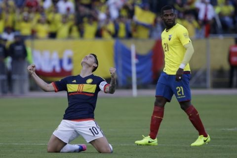 Colombia's James Rodriguez celebrates after his team beat Ecuador 2-0 next to Ecuador's Gabriel Achilier at the end of their 2018 World Cup qualifying soccer match at the Atahualpa Olympic Stadium in Quito, Ecuador, Tuesday, March 28, 2017. (AP Photo/Fernando Vergara)