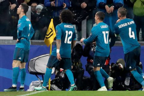 Real Madrid's Cristiano Ronaldo, left, celebrates after scoring the second goal of his team during the Champions League, round of 8, first-leg soccer match between Juventus and Real Madrid at the Allianz stadium in Turin, Italy, Tuesday, April 3, 2018. (AP Photo/Luca Bruno)