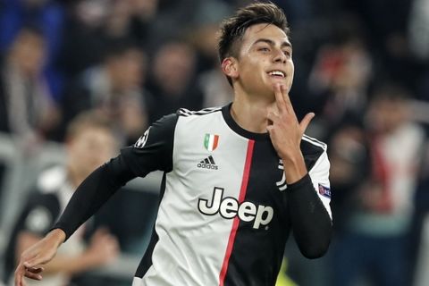 Juventus' Paulo Dybala celebrates after scoring the opening goal during the Champions League group D soccer match between Juventus and Atletico Madrid at the Allianz stadium in Turin, Italy, Tuesday, Nov. 26, 2019. (AP Photo/Antonio Calanni)