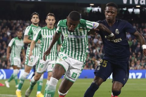 Betis' Emerson fights for the ball against Real Madrid's Vinicius Junior during La Liga soccer match between Betis and Real Madrid at the Benito Villamarin stadium in Seville, Spain, Sunday, March. 8, 2020. (AP Photo/Miguel Morenatti)