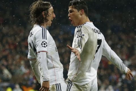 Real's Cristiano Ronaldo, right, celebrates with Luka Modric after scoring his side's 3rd goal during a Champions League quarterfinal first leg soccer match between Real Madrid and Borussia Dortmund at the Santiago Bernabeu   stadium in Madrid, Spain, Wednesday, April 2, 2014. (AP Photo/Andres Kudacki)