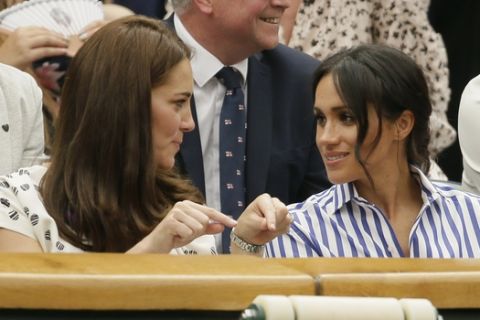 Kate, Duchess of Cambridge and Meghan, Duchess of Sussex, right, sit in the Royal Box on Centre Court ahead of the women's singles final match between Serena Williams of the US and Angelique Kerber of Germany at the Wimbledon Tennis Championships, in London, Saturday July 14, 2018. (AP Photo/Tim Ireland)