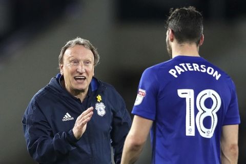 Cardiff City manager Neil Warnock, left, and Callum Paterson speak during the Sky Bet Championship match at Pride Park, DerbyTuesday April 24, 2018. (Nick Potts/PA via AP)