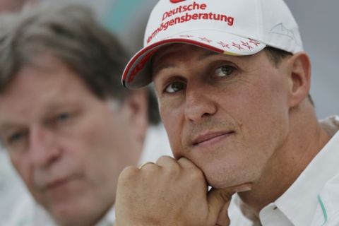 FILE - In this Thursday, Oct. 4, 2012 file photo, former Mercedes F1 driver Michael Schumacher of Germany pauses during a news conference to announce his retirement from Formula One at the end of  2012  in Suzuka, Japan.  Former Formula One world champion Michael Schumacher has left hospital to continue his recovery at home, his manager said Tuesday. The seven-time champion suffered a serious head injury while skiing in France in December, resulting in him being put in a coma. (AP Photo/Shizuo Kambayashi, File)