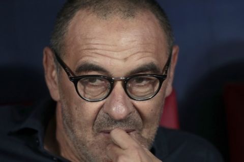 Juventus' head coach Maurizio Sarri takes his seat on the bench prior to the Champions League Group D soccer match between Atletico Madrid and Juventus at the Wanda Metropolitano stadium in Madrid, Spain, Wednesday, Sept. 18, 2019. (AP Photo/Bernat Armangue)
