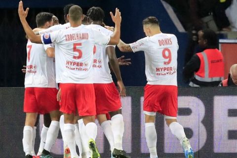 Reims players celebrate after Reims' Hassane Kamara scored his side opening goal during the French League One soccer match between PSG and Reims at the Parc des Princes stadium in Paris, Wednesday, Sept. 25, 2019. (AP Photo/Michel Euler)