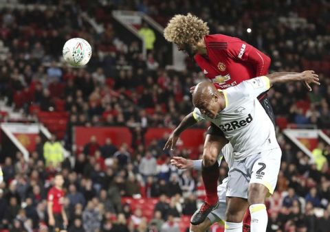 Manchester United's Marouane Fellaini, top right, scores his side's second goal of the game against Derby County during the English League Cup, third round soccer match at Old Trafford in Manchester, England, Tuesday Sept. 25, 2018. (Martin Rickett/PA via AP)