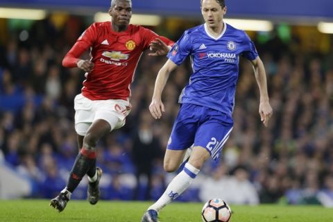 Chelsea's Nemanja Matic, right, takes the ball away from Manchester United's Paul Pogba during the English FA Cup quarterfinal soccer match between Chelsea and Manchester United at Stamford Bridge stadium in London, Monday, March 13, 2017 (AP Photo/Alastair Grant)