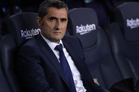 Barcelona coach Ernesto Valverde takes his seat prior to a Spanish La Liga soccer match between FC Barcelona and Atletico Madrid at the Camp Nou stadium in Barcelona, Spain, Saturday April 6, 2019. (AP Photo/Manu Fernandez)