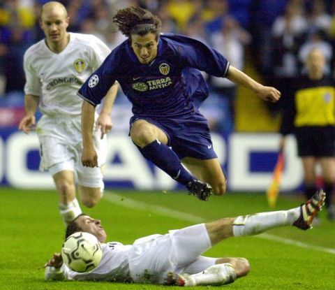 Valencia's Zlatko Zahovic leaps over Leeds United's Lee Bowyer during the UEFA Champion's League first leg semi final match at Elland Road Stadium in Leeds, England, Wednesday May 2, 2001. The match ended in a scoreless draw. (AP Photo/Paul Barker)