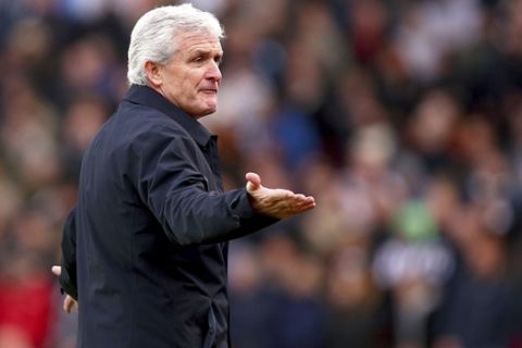Stoke City manager Mark Hughes gestures on the touchline during the match against Newcastle United, during their English Premier League soccer match at the bet365 Stadium in Stoke, England, Monday Jan. 1, 2018. (Dave Thompson/PA via AP)