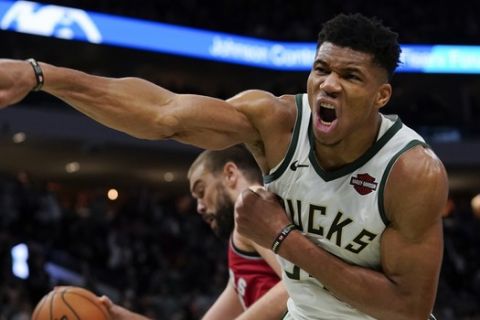 Milwaukee Bucks' Giannis Antetokounmpo reacts after his dunk during the second half of an NBA basketball game against the Toronto Raptors Saturday, Nov. 2, 2019, in Milwaukee. The Bucks won 115-105. (AP Photo/Morry Gash)
