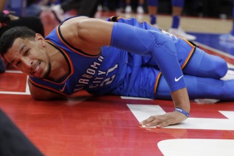 Oklahoma City Thunder guard Andre Roberson lies on the court after slipping during the second half of the team's NBA basketball game against the Detroit Pistons, Saturday, Jan. 27, 2018, in Detroit. (AP Photo/Carlos Osorio)
