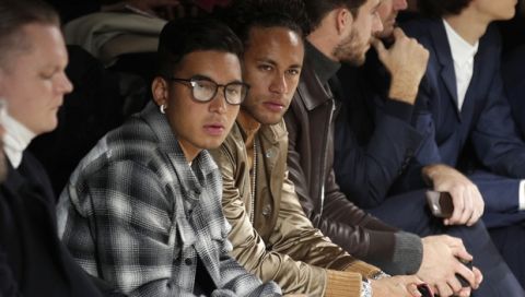 Soccer player Neymar, centre, watches the Louis Vuitton men's Fall-Winter 2018/2019 fashion collection presented in Paris, Thursday, Jan.18, 2018. (AP Photo/Francois Mori)
