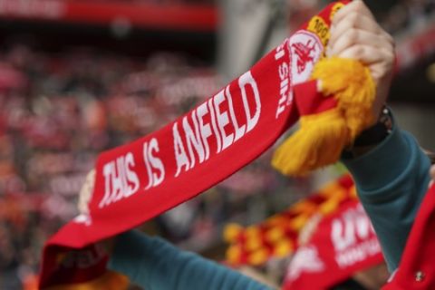 Liverpool fan hold a scarf during the English Premier League soccer match between Liverpool and Bournemouth at Anfield stadium in Liverpool, England, Saturday, March 7, 2020. (AP Photo/Jon Super)