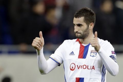 Lyon's Maxime Gonalons cheers to supporters after his team's victory at the end of his Europa League round of 16 first leg soccer match against Roma in Decines, near Lyon, central France, Thursday, March 9, 2017. (AP Photo/Claude Paris)