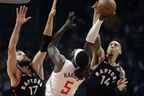 Toronto Raptors' Danny Green (14) blocks a shot by Los Angeles Clippers' Montrezl Harrell (5) as the Raptors' Jonas Valanciunas (17) also defends during the first half of an NBA basketball game, Tuesday, Dec. 11, 2018, in Los Angeles. (AP Photo/Marcio Jose Sanchez)