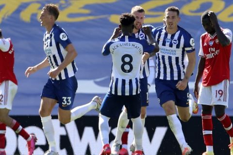 Brighton's Lewis Dunk, 2nd right, celebrates after scoring his side's first goal during the English Premier League soccer match between Brighton & Hove Albion and Arsenal at the AMEX Stadium in Brighton, England, Saturday, June 20, 2020. (Gareth Fuller/Pool via AP)