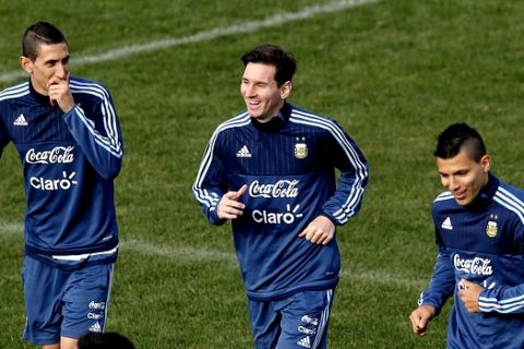 Argentina's Angel Di Maria, from left, Lionel Messi, and Sergio Aguero, jog during a training session in Vina del Mar, Chile, Saturday, June 27, 2015. Argentina defeated Colombia 5-4 on penalties after a 0-0 draw on Friday to reach the semifinals of the Copa America. (AP Photo/Andre Penner)