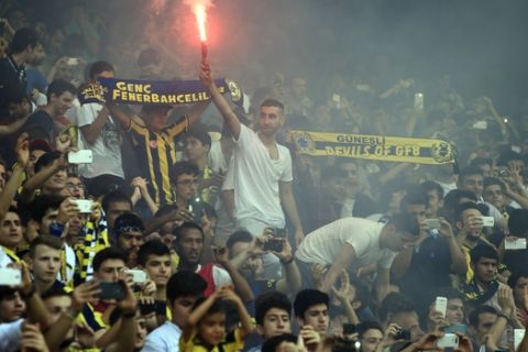 Fenerbahce fans celebrate as Robin Van Persie, of Netherlands, is presented at the team's Sukru Saracoglu Stadium in Istanbul, Tuesday, July 14, 2015. The 31-year-old former Arsenal, Feyenoord and Manchester United striker links up with his former United teammate Nani, who signed for the Istanbul club last week. (AP Photo/Lefteris Pitarakis)