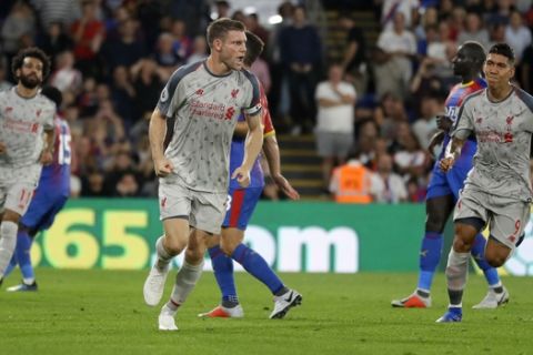 Liverpool's James Milner, center, celebrates after scoring his side's opening goal from penalty during the English Premier League soccer match between Crystal Palace and Liverpool at Selhurst Park stadium in London, Monday, Aug. 20, 2018. (AP Photo/Kirsty Wigglesworth)