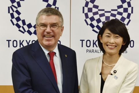 IOC President Thomas Bach, left, and Japan's Olympic Minister Tamayo Marukawa smile as they pose for photographer during their meeting in Tokyo Tuesday, Oct. 18, 2016. (Japan Pool Photo via AP)