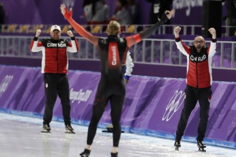 Canadian coaches celebrate after Ted-Jan Bloemen, center, of Canada set a new Olympic record breaking the one that Jorrit Bergsma of The Netherlands set in the previous race of the men's 10,000 meters speedskating race at the Gangneung Oval at the 2018 Winter Olympics in Gangneung, South Korea, Thursday, Feb. 15, 2018. (AP Photo/Petr David Josek)