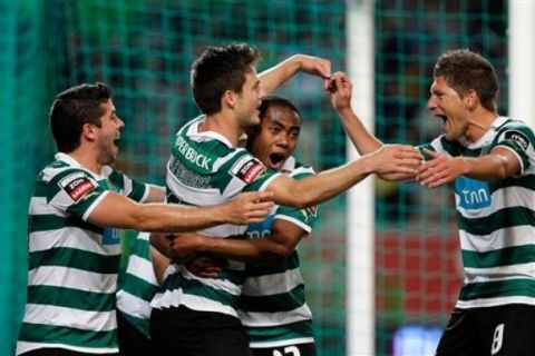 Sporting's players celebrate after Ricky van Wolfswinkel, from the Netherlands, second left, scored the opening goal against Benfica during their Portuguese league soccer match Monday, April 9 2012, at Sporting's Alvalade stadium. (AP Photo/Armando Franca)