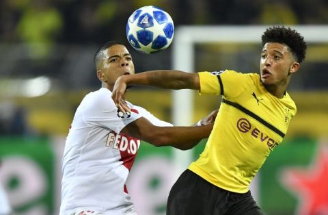 Dortmund's Jadon Sancho, right, fights for the ball with Monaco defender Benjamin Henrichs during the Champions League group A soccer match between Borussia Dortmund and AS Monaco in Dortmund, Germany, Wednesday, Oct. 3, 2018. (AP Photo/Martin Meissner)