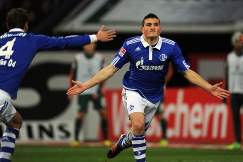 Schalke's Greek defender Kyriakos Papadopoulos celebrates after scoring during the German first division Bundesliga football match FC Schalke 04 vs Werder Bremen in the German city of Gelsenkirchen on December 17, 2011. Schalke won 5-0.
AFP PHOTO / PATRIK STOLLARZ

RESTRICTIONS / EMBARGO - DFL LIMITS THE USE OF IMAGES ON THE INTERNET TO 15 PICTURES (NO VIDEO-LIKE SEQUENCES) DURING THE MATCH AND PROHIBITS MOBILE (MMS) USE DURING AND FOR FURTHER TWO HOURS AFTER THE MATCH. FOR MORE INFORMATION CONTACT DFL. (Photo credit should read PATRIK STOLLARZ/AFP/Getty Images)
