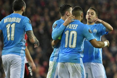 Teammates congratulate Marseille's Dimitri Payet after Payet scored his side opening goal during their Europa League round of 16, 2nd leg, match between Athletic Bilbao and Olympique Marseille, at San Mames stadium, in Bilbao, northern Spain, Thursday, March 15, 2018. (AP Photo/Alvaro Barrientos)