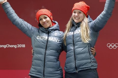 Driver Mariama Jamanka, right, and Lisa Buckwitz, right, of Germany celebrate winning the gold medal during the women's two-man bobsled final at the 2018 Winter Olympics in Pyeongchang, South Korea, Wednesday, Feb. 21, 2018. (AP Photo/Andy Wong)