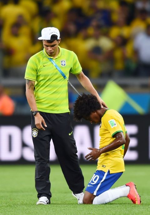 BELO HORIZONTE, BRAZIL - JULY 08:  Thiago Silva of Brazil consoles Willian after Germany's 7-1 win during the 2014 FIFA World Cup Brazil Semi Final match between Brazil and Germany at Estadio Mineirao on July 8, 2014 in Belo Horizonte, Brazil.  (Photo by Buda Mendes/Getty Images)