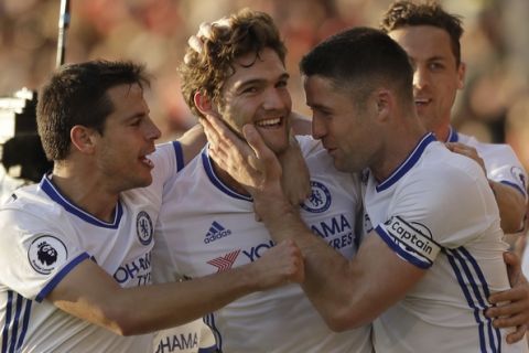 Chelsea's Marcos Alonso, centre celebrates with his teammates after scoring his sides 3rd goal during their English Premier League soccer match between Bournemouth and Chelsea at Dean Court stadium in Bournemouth, England, Saturday, April 8, 2017. (AP Photo/Matt Dunham)