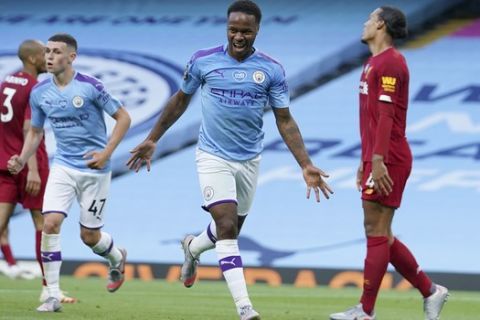 Manchester City's Raheem Sterling celebrates after scoring his team's second goal during the English Premier League soccer match between Manchester City and Liverpool at Etihad Stadium in Manchester, England, Thursday, July 2, 2020. (AP Photo/Dave Thompson,Pool)