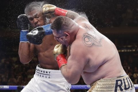 Andy Ruiz, right, and Anthony Joshua exchange punches during the seventh round of a heavyweight championship boxing match Saturday, June 1, 2019, in New York. Ruiz won in the seventh round. (AP Photo/Frank Franklin II)