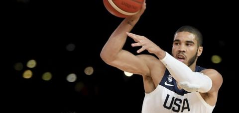 United States' Jayson Tatum, right, passes past Australia's Nathan Sobey during their exhibition basketball game in Melbourne, Australia, Thursday, Aug. 22, 2019. (AP Photo/Andy Brownbill)