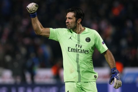 PSG goalkeeper Gianluigi Buffon raises his fist as he reacts after PSG forward Kylian Mbappe scored his side's fourth goal during the Champions League group C soccer match between Red Star and Paris Saint Germain, in Belgrade, Serbia, Tuesday, Dec. 11, 2018. (AP Photo/Darko Vojinovic)